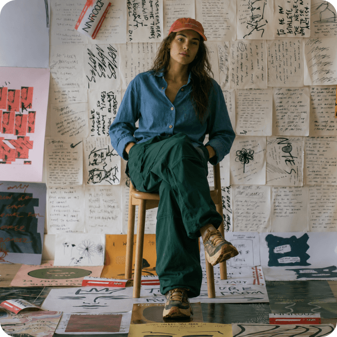 Creator working in a studio surrounded by handwritten notes